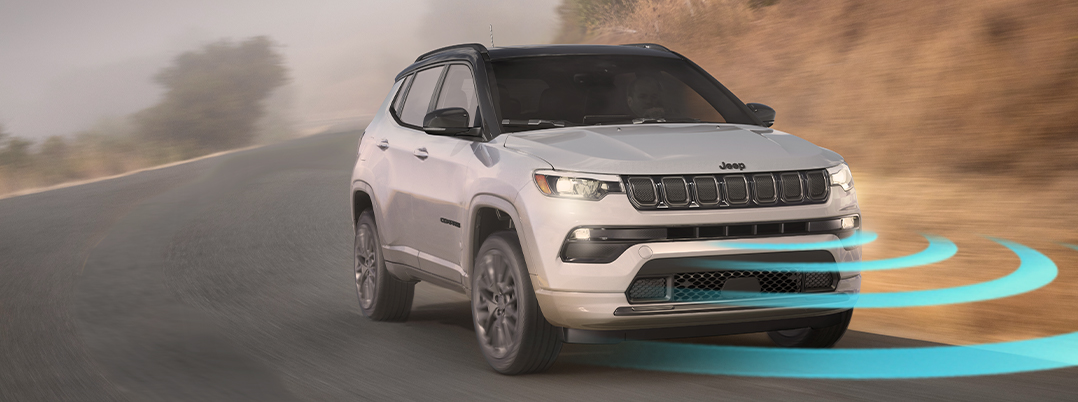 The 2022 Jeep Compass Limited with illustrated sensor bars emanating from its front grille.