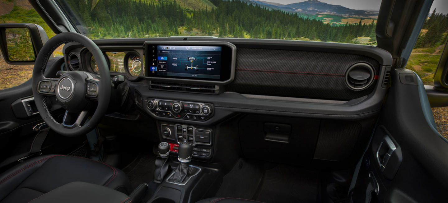 The front seats in the 2025 Jeep Gladiator Mojave, with "Mojave" embroidered on the seats, just below the headrests.