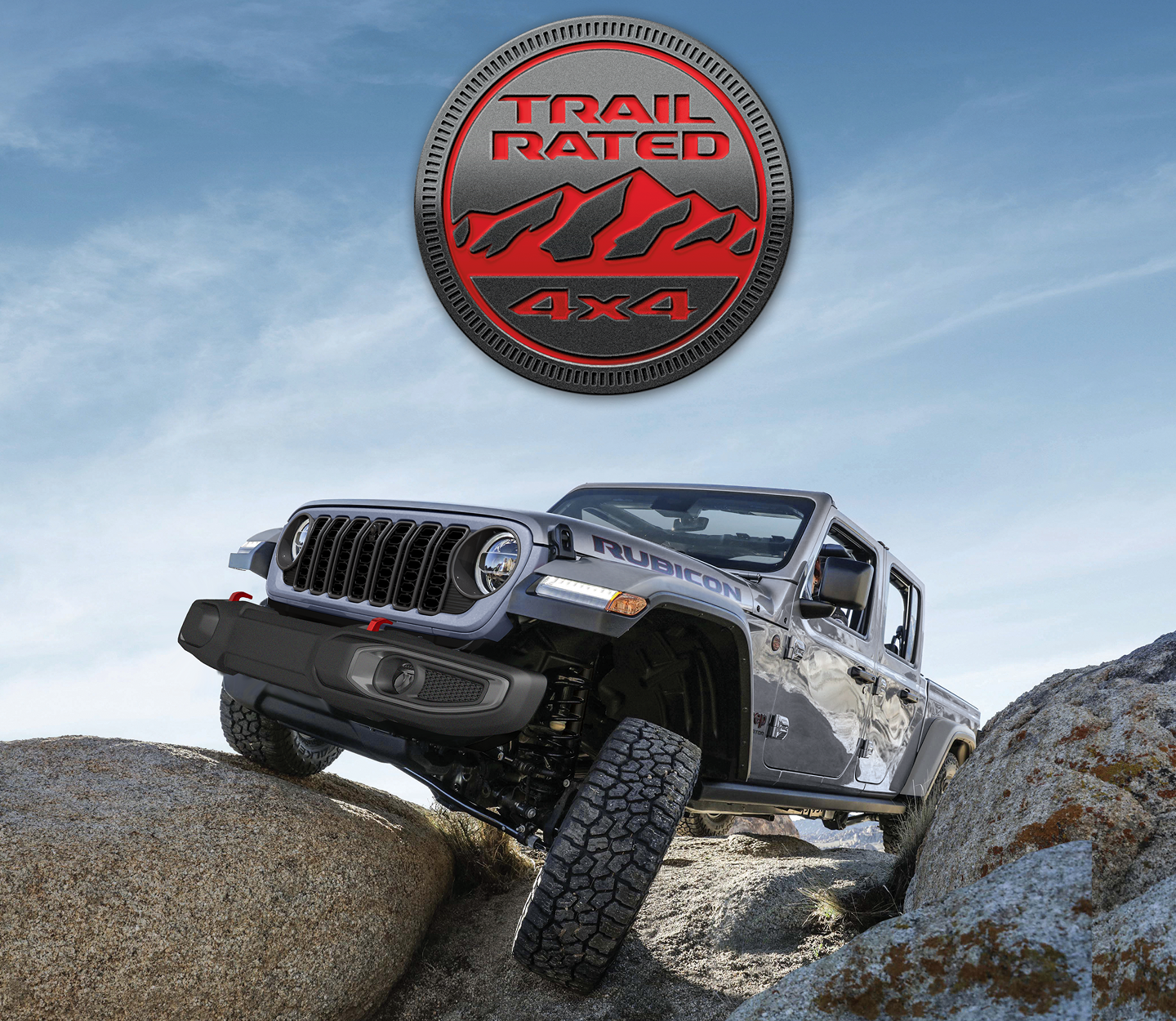 A red 2025 Jeep Gladiator Rubicon X with its roof removed, crawling over a series of boulders and outcroppings off-road. The Trail Rated 4x4 badge.
