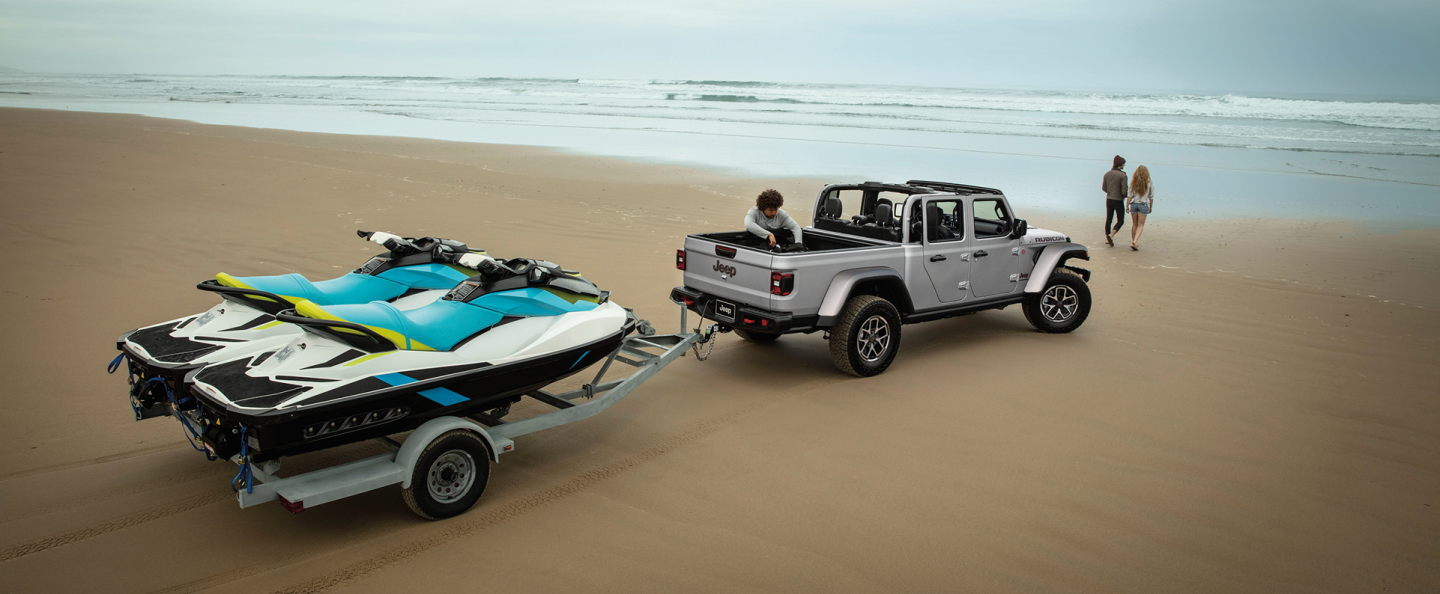 The steering wheel, Digital Cluster Display, Uconnect touchscreen and center stack controls in the 2025 Jeep Gladiator, with the touchscreen displaying the Vehicle Dynamics section of the Off-Road Pages.