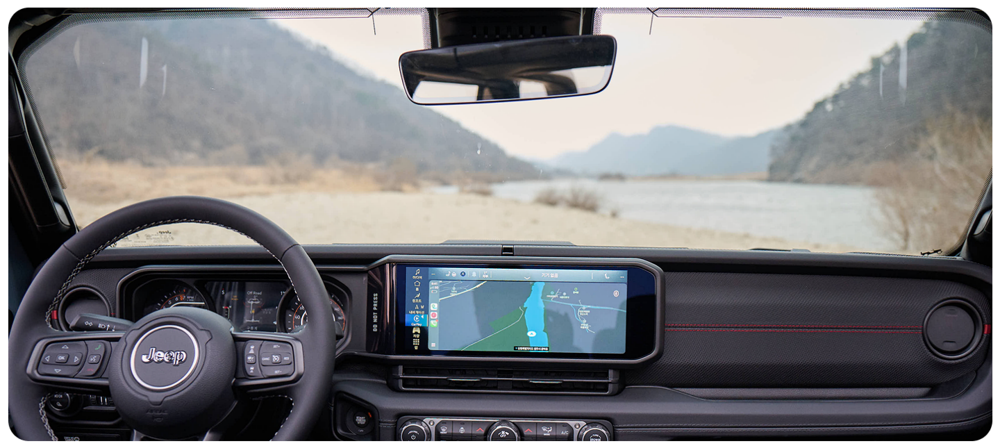 The Uconnect touchscreen in a 2026 Jeep Wrangler displaying a page in the Off-Road Trail Guide from Trails Offroad.